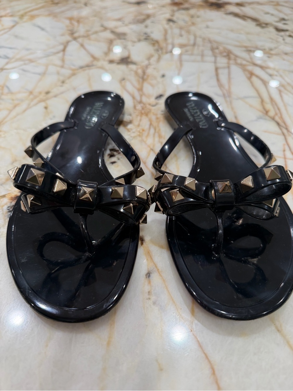 Valentino Garavani Black Jelly Bow Sandals with Gold Pyramid Studs